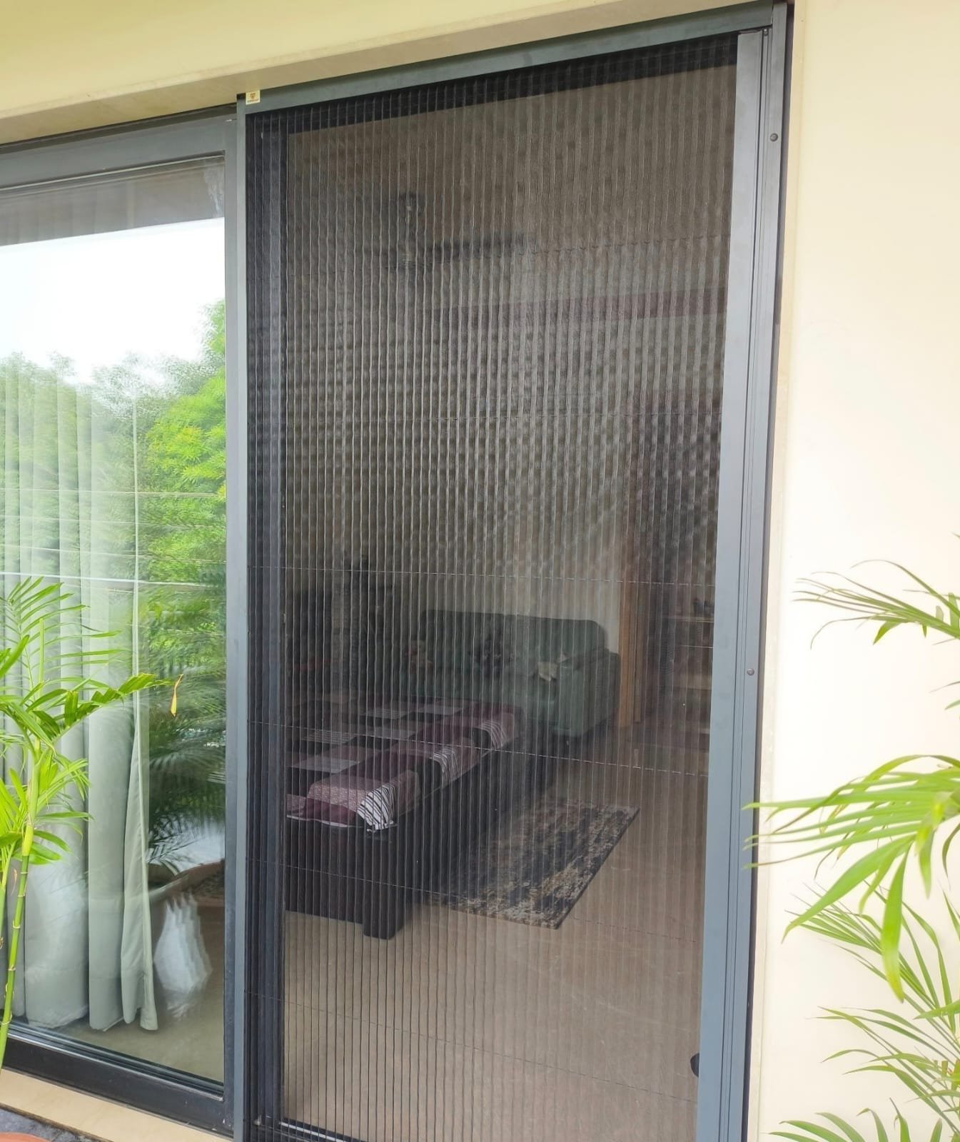 Pleated mosquito net door installed at a residence