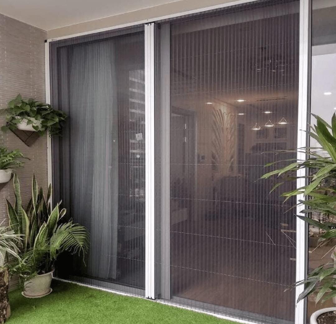 Pleated mosquito net installed on a large balcony sliding door